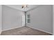 Cozy bedroom with a window providing natural light and neutral colored walls and carpet at 212 Kissengen Park Dr, Bartow, FL 33830