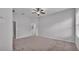 Bright bedroom featuring a ceiling fan, neutral walls, and access to the bathroom at 212 Kissengen Park Dr, Bartow, FL 33830