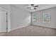 Bedroom with plush carpet, a neutral color palette, two windows and a doorway at 212 Kissengen Park Dr, Bartow, FL 33830