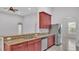 Kitchen featuring granite counters, cherry cabinets, stainless refrigerator, and an open floorplan at 212 Kissengen Park Dr, Bartow, FL 33830