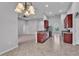 Open concept kitchen featuring stainless steel appliances, cherry cabinets, and granite countertops at 212 Kissengen Park Dr, Bartow, FL 33830