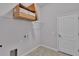 Functional laundry room with tile flooring, wire shelving, and neutral paint at 212 Kissengen Park Dr, Bartow, FL 33830