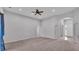 Large living room with ceiling fan, neutral carpet, and open floor plan at 212 Kissengen Park Dr, Bartow, FL 33830