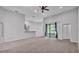 The living room features a ceiling fan, neutral carpet, and a view of the lanai at 212 Kissengen Park Dr, Bartow, FL 33830