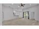 Bright living room features carpet, ceiling fan, and sliding glass doors to a patio at 212 Kissengen Park Dr, Bartow, FL 33830