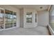 Spacious screened porch with sliding glass doors and view of backyard at 212 Kissengen Park Dr, Bartow, FL 33830