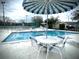 Relaxing community pool with patio tables and umbrellas at 2141 Sandy Hook, Lakeland, FL 33813