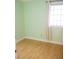 This bedroom offers hardwood flooring, a window, and light green walls at 223 Windsor St # 3A, Lakeland, FL 33803