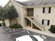 Exterior view of a building with well-maintained landscaping and stairs to the entrances at 223 Windsor St # 3A, Lakeland, FL 33803