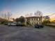 Beautiful two-story apartment building with ample parking and manicured landscaping during a colorful sunrise at 223 Windsor St # 3A, Lakeland, FL 33803