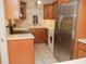 Well-lit kitchen with stainless steel refrigerator and light wood cabinetry at 223 Windsor St # 3A, Lakeland, FL 33803