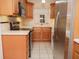 Well-lit kitchen with stainless steel refrigerator and light wood cabinetry at 223 Windsor St # 3A, Lakeland, FL 33803