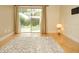 Bright living room featuring hardwood floors, neutral walls, an area rug, and sliding glass doors to the outdoors at 223 Windsor St # 3A, Lakeland, FL 33803