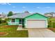 Cute teal house with a 1-car garage and well-maintained lawn at 2266 Silver Re Dr, Lakeland, FL 33810