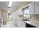 Kitchen with white cabinets, sink, and view to backyard at 2266 Silver Re Dr, Lakeland, FL 33810