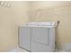 Bright laundry room with washer, dryer, and shelving at 2266 Silver Re Dr, Lakeland, FL 33810