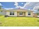 Single story home with grassy backyard and covered patio at 237 Piave St, Haines City, FL 33844