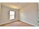 Well-lit bedroom featuring a window and plush carpeting at 237 Piave St, Haines City, FL 33844