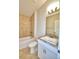 Bathroom with tub, toilet, vanity, and tile surround at 245 Piave St, Haines City, FL 33844