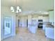 Dining area with chandelier, and view into kitchen and Gathering room at 245 Piave St, Haines City, FL 33844