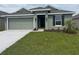 Charming one-story home with a well-manicured lawn, tidy landscaping, and a two-car garage at 245 Piave St, Haines City, FL 33844