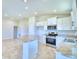 Open concept kitchen with stainless steel appliances and an island at 245 Piave St, Haines City, FL 33844