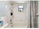 Bathroom with tub, shower, and gray curtain at 3220 Cherry Hill S Cir, Lakeland, FL 33810