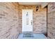 White front door with a glass panel and a welcome mat at 3220 Cherry Hill S Cir, Lakeland, FL 33810