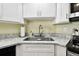 Kitchen corner sink with granite countertop and white cabinets at 3220 Cherry Hill S Cir, Lakeland, FL 33810