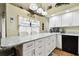 Modern kitchen with granite countertops and white cabinets at 3220 Cherry Hill S Cir, Lakeland, FL 33810