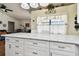 White kitchen island with granite countertop, offering ample storage and seating at 3220 Cherry Hill S Cir, Lakeland, FL 33810