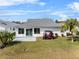 House with patio, golf cart, and palm trees in the backyard at 3273 Pebble Bend Dr, Lakeland, FL 33810