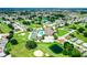 An aerial view shows the neighborhood's golf course, clubhouse, and swimming pool at 3273 Pebble Bend Dr, Lakeland, FL 33810