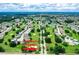 An aerial view of a golf community and homes, showing the community entrance and lush landscaping at 3273 Pebble Bend Dr, Lakeland, FL 33810