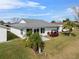 Rear view of a house with a golf cart and patio at 3273 Pebble Bend Dr, Lakeland, FL 33810