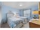 Light and airy bedroom with twin beds, dresser, and light blue walls at 3273 Pebble Bend Dr, Lakeland, FL 33810