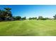 A scenic golf course surrounds a clubhouse on a clear day at 3273 Pebble Bend Dr, Lakeland, FL 33810