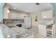 Clean kitchen featuring white cabinets, granite countertops, and stainless steel appliances at 3273 Pebble Bend Dr, Lakeland, FL 33810