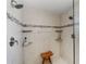 Spacious shower with dual shower heads, built-in shelving, and tiled walls at 3273 Pebble Bend Dr, Lakeland, FL 33810