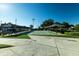 An outdoor shuffleboard court is surrounded by covered seating areas and green hedges at 3273 Pebble Bend Dr, Lakeland, FL 33810