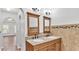 Double vanity bathroom with granite countertop and large mirrors at 3445 Sleepy Hill Oaks St, Lakeland, FL 33810