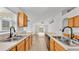 Kitchen with wood cabinets, black appliances, and double sinks at 3445 Sleepy Hill Oaks St, Lakeland, FL 33810