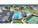 Aerial view of community clubhouse with pool, tennis courts, shuffleboard, and golf course at 3618 Highland Fairways Blvd, Lakeland, FL 33810