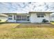 Back exterior with covered patio and lawn at 3618 Highland Fairways Blvd, Lakeland, FL 33810