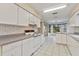 Kitchen with white cabinets, laminate countertops and tile floor at 3618 Highland Fairways Blvd, Lakeland, FL 33810