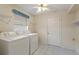 Laundry room with washer, dryer, and storage shelves at 3618 Highland Fairways Blvd, Lakeland, FL 33810