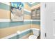 Powder room with stylish striped walls at 4003 Solamor St, Lakeland, FL 33810