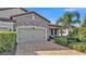 Two-car garage with paver driveway and nicely landscaped front yard at 4003 Solamor St, Lakeland, FL 33810