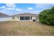 Backyard view of house with screened porch and grill at 4009 Oakley Way, Lakeland, FL 33813