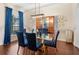 Elegant dining room featuring a glass table, blue chairs, and a china cabinet at 4009 Oakley Way, Lakeland, FL 33813